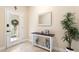 Welcoming foyer with a decorative mirror, table with decor, tile floor, and a lovely plant at 6345 Vista Verde E Dr, Gulfport, FL 33707