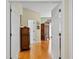Inviting hallway with hardwood floors, decorative furniture, and neutral paint scheme showcasing the home's design at 6345 Vista Verde E Dr, Gulfport, FL 33707