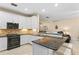 An open kitchen features white cabinets, granite countertops, and an eat-in breakfast bar at 6345 Vista Verde E Dr, Gulfport, FL 33707