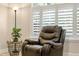 Cozy seating area featuring a plush recliner, side table, and abundant natural light at 6345 Vista Verde E Dr, Gulfport, FL 33707