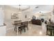 Open-concept living and dining areas featuring tile floors, a modern light fixture and comfortable furniture at 6345 Vista Verde E Dr, Gulfport, FL 33707