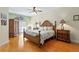 Spacious main bedroom with a ceiling fan, decorative wardrobe, and comfortable bed is move-in ready at 6345 Vista Verde E Dr, Gulfport, FL 33707
