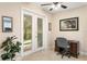 Bright office space with ceiling fan, desk, and outdoor access at 6345 Vista Verde E Dr, Gulfport, FL 33707