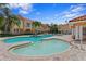 Inviting community pool and hot tub surrounded by lush landscaping and Mediterranean-style buildings under a bright, sunny sky at 6345 Vista Verde E Dr, Gulfport, FL 33707