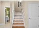 Stairway leading to the second floor, featuring wood steps and white risers at 6345 Vista Verde E Dr, Gulfport, FL 33707