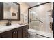 Bathroom features a large shower with glass door and dark wood vanity at 7069 Key Haven Rd # 205, Seminole, FL 33777