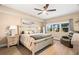 This cozy bedroom features hardwood floors, and a sitting area near the window at 7069 Key Haven Rd # 205, Seminole, FL 33777
