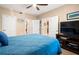 Spacious bedroom with wood floors, ceiling fan, and a view to other rooms at 7069 Key Haven Rd # 205, Seminole, FL 33777