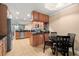 Open-concept kitchen features stainless steel appliances, wooden cabinetry, and tiled flooring at 7069 Key Haven Rd # 205, Seminole, FL 33777