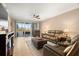 Open-concept living room with leather sofas, tile flooring, and screened lanai access at 7069 Key Haven Rd # 205, Seminole, FL 33777
