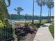 Community tennis courts with new fencing, sidewalk and palm trees at 7069 Key Haven Rd # 205, Seminole, FL 33777