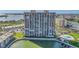 Wide aerial view of the high-rise condo highlighting its many balconies, waterfront location with a marina, and convenient amenities at 7300 Sun Island S Dr # 802, South Pasadena, FL 33707