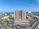 Elevated view of the condo building, showing the building's landscaping, parking area and waterfront views, all under a sunny sky at 7300 Sun Island S Dr # 802, South Pasadena, FL 33707