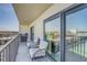 Balcony featuring cushioned chairs, table, railing with views of waterfront neighborhood at 7300 Sun Island S Dr # 802, South Pasadena, FL 33707