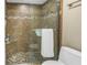 Bathroom featuring a glass shower door, tiled shower, granite bench, and toilet at 7300 Sun Island S Dr # 802, South Pasadena, FL 33707
