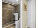 Bathroom featuring a glass shower door, tiled shower, granite bench, and toilet at 7300 Sun Island S Dr # 802, South Pasadena, FL 33707