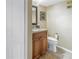 Cozy bathroom featuring a granite vanity, wood cabinets and a toilet at 7300 Sun Island S Dr # 802, South Pasadena, FL 33707