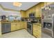 Kitchen flows into living area with granite countertops and stainless steel appliances at 7300 Sun Island S Dr # 802, South Pasadena, FL 33707