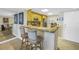 Bright kitchen featuring granite countertops, wooden cabinets, and barstool seating at 7300 Sun Island S Dr # 802, South Pasadena, FL 33707