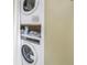 A compact laundry area equipped with a stacked washer and dryer unit at 7300 Sun Island S Dr # 802, South Pasadena, FL 33707