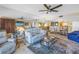 Comfortable living room with ample seating, mirrored wall, and access to dining area at 7300 Sun Island S Dr # 802, South Pasadena, FL 33707