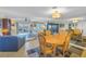 Open concept living and dining area with tile floors, ceiling fan, and water view at 7300 Sun Island S Dr # 802, South Pasadena, FL 33707