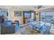 Inviting living room with balcony access, ceiling fan, and water views at 7300 Sun Island S Dr # 802, South Pasadena, FL 33707