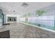 Condominium lobby area with mailboxes along a mural-covered wall and seating area visible at end of hall at 7300 Sun Island S Dr # 802, South Pasadena, FL 33707