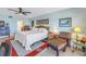 Bright main bedroom featuring a ceiling fan, sitting area and colorful artwork at 7300 Sun Island S Dr # 802, South Pasadena, FL 33707