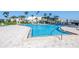A luxurious swimming pool surrounded by palm trees and lounge chairs for relaxing and soaking up the sun at 7300 Sun Island S Dr # 802, South Pasadena, FL 33707
