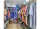 Walk-in closet with ventilated shelving, wooden cabinets, and tiled floor at 7300 Sun Island S Dr # 802, South Pasadena, FL 33707