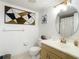 Bathroom featuring an oval mirror, vanity with sink, and a mosaic art piece at 8709 Wabash Ln, Port Richey, FL 34668