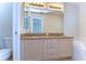 Bathroom with dual sinks, granite countertop, and natural lighting at 8907 Ashford Gables, Tampa, FL 33626