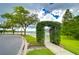 Picturesque community entrance adorned with lush greenery, providing a welcoming and scenic environment at 8907 Ashford Gables, Tampa, FL 33626