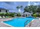 Resort-style community pool with comfortable lounge chairs, creating a perfect oasis for relaxation and enjoyment at 8907 Ashford Gables, Tampa, FL 33626