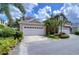 Charming two-story home showcasing a well-maintained yard and a two-car garage, enhancing curb appeal at 8907 Ashford Gables, Tampa, FL 33626