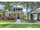 Charming two-story home with a landscaped front yard, mature trees, and inviting curb appeal in a desirable community at 8907 Ashford Gables, Tampa, FL 33626