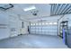 Spacious two-car garage with epoxy flooring and built-in storage cabinets, offering ample space for vehicles and storage at 8907 Ashford Gables, Tampa, FL 33626