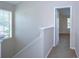 Hallway featuring carpet, leading to a bright room with natural light at 8907 Ashford Gables, Tampa, FL 33626