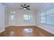 Bright living room with hardwood floors, crown molding, ceiling fan, and a door with sidelight window at 8907 Ashford Gables, Tampa, FL 33626