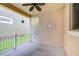 Private outdoor patio with ceiling fan, screened area, and neutral tones at 8907 Ashford Gables, Tampa, FL 33626