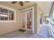 Inviting outdoor patio with French doors and a view of the surrounding landscape at 8907 Ashford Gables, Tampa, FL 33626