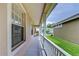 Covered porch with white columns, offering a relaxing outdoor space with views of the neighborhood at 8907 Ashford Gables, Tampa, FL 33626