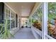 Long, covered porch with views of the landscaped yard, providing an inviting outdoor space at 8907 Ashford Gables, Tampa, FL 33626