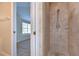 Elegant bathroom shower featuring neutral stone tiling and sleek fixtures, providing a spa-like experience at 8907 Ashford Gables, Tampa, FL 33626