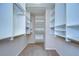 Well-organized walk-in closet with custom shelving, providing ample storage space for clothing and accessories at 8907 Ashford Gables, Tampa, FL 33626