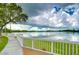 Serene lake view showcasing a walking path and a pristine body of water, creating a tranquil and inviting atmosphere at 8907 Ashford Gables, Tampa, FL 33626