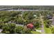 Stunning aerial view of home with a red roof, surrounded by lush greenery near the Alafia River at 9501 Alice Ln, Riverview, FL 33578