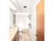 Neutral-toned bathroom with marble vanity, shower-tub, and ample natural light at 9501 Alice Ln, Riverview, FL 33578