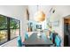 Bright dining area features modern lighting, stylish decor, and serene views of the outdoor landscape at 9501 Alice Ln, Riverview, FL 33578